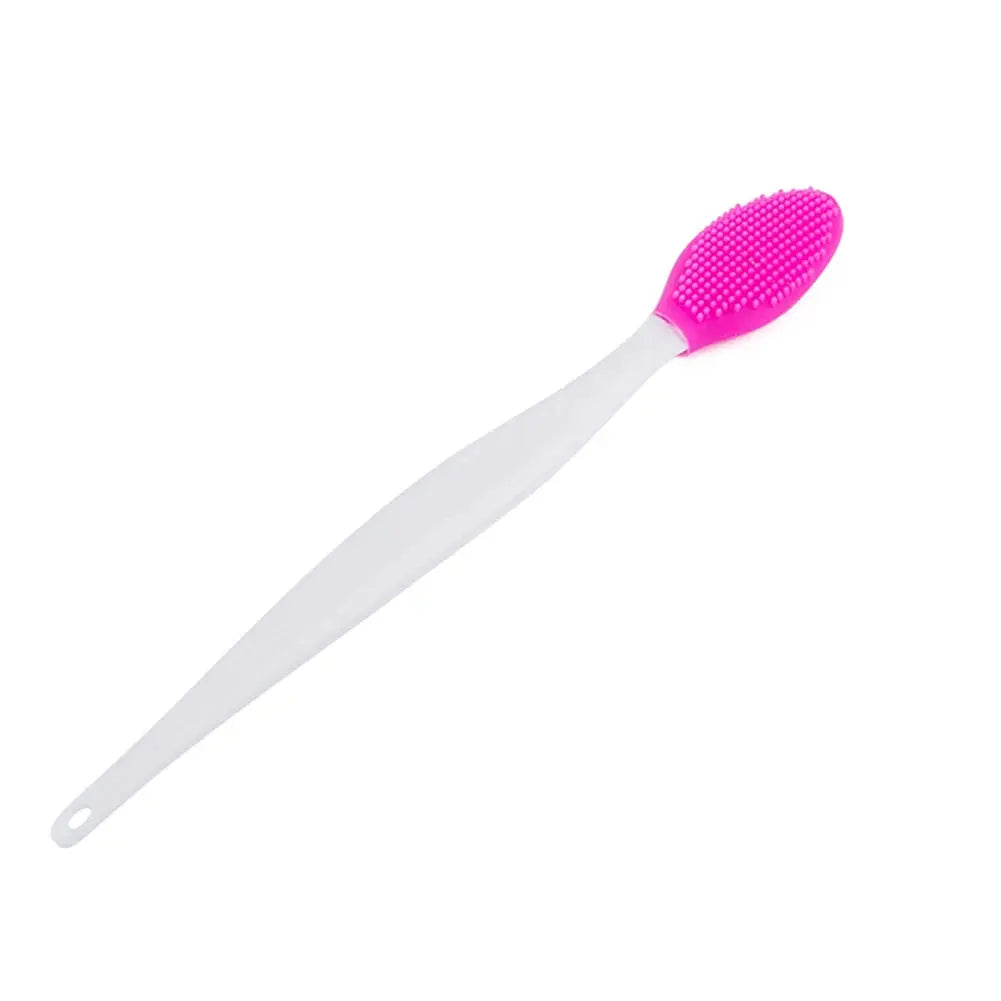 Pink silicone facial cleansing brush with textured head and white handle, close-up