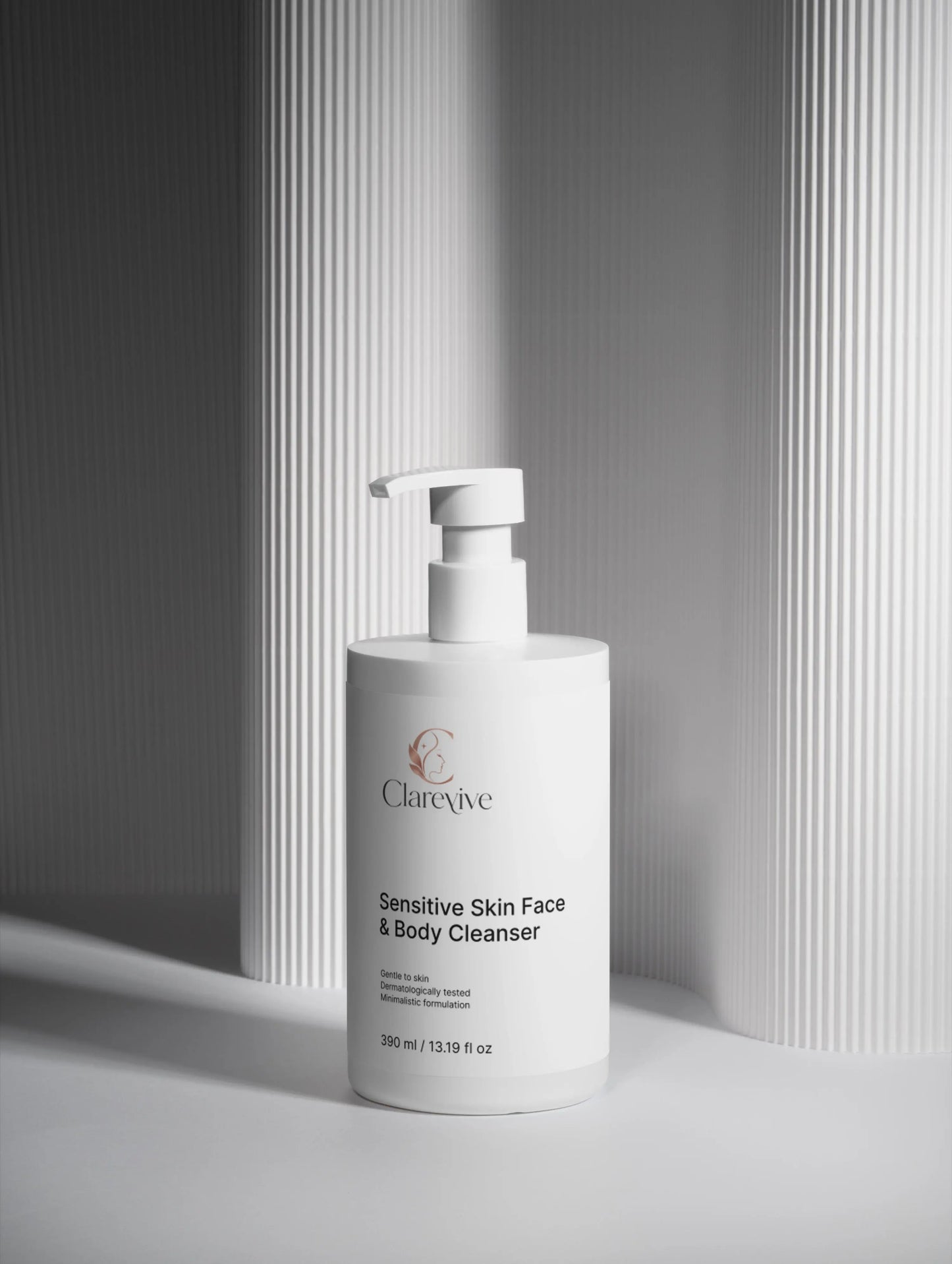 White cleanser bottle with pump dispenser, front label for sensitive skin face & body