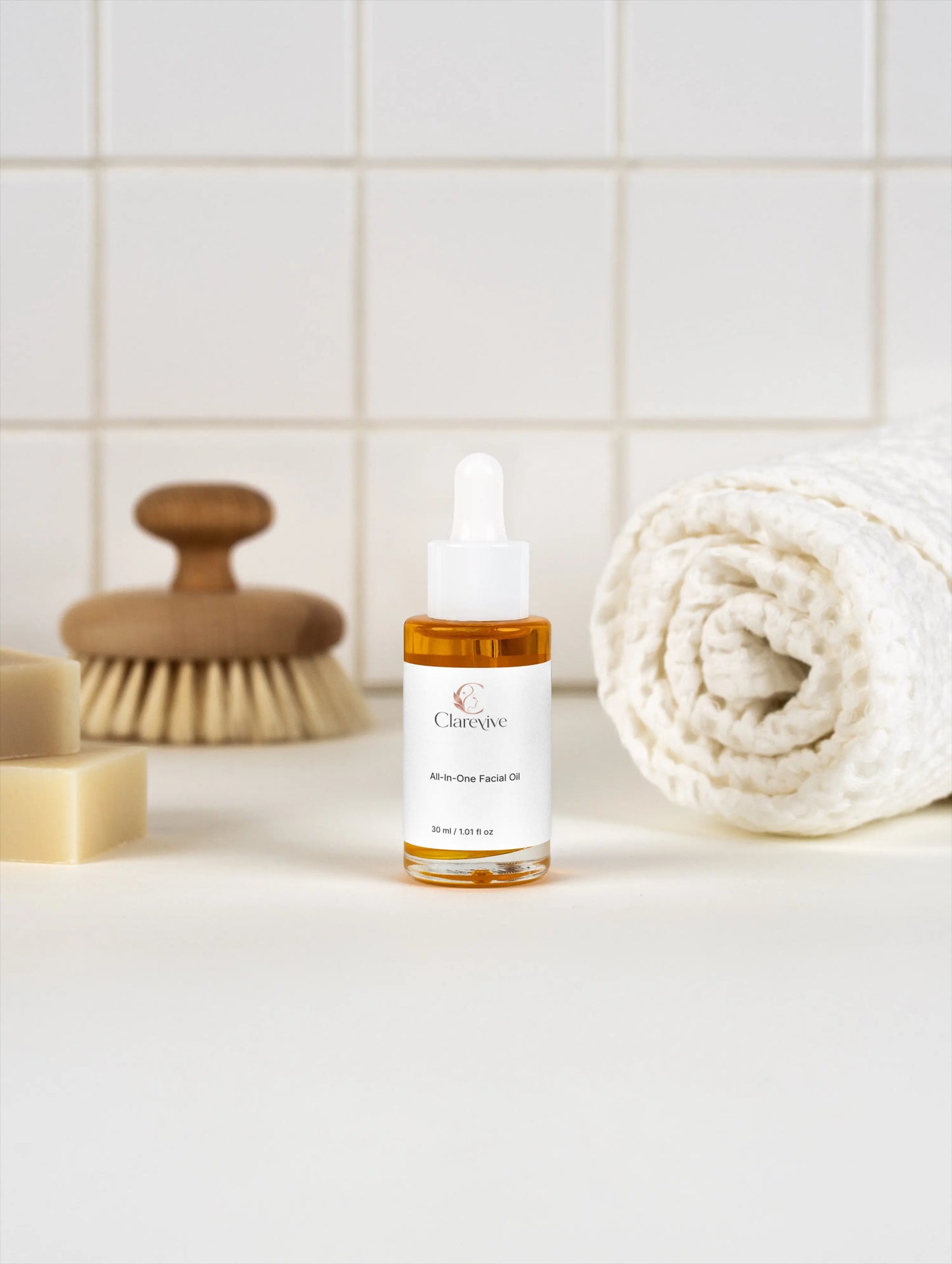 All-in-one facial oil bottle with white dropper, amber liquid
