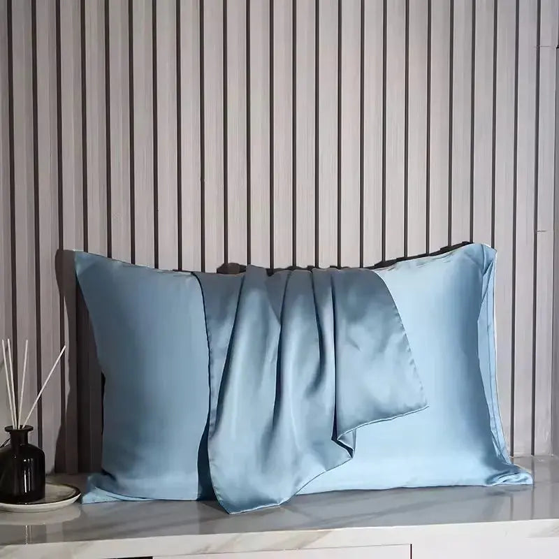 Powder blue silk pillowcase with glossy satin surface and folded flap