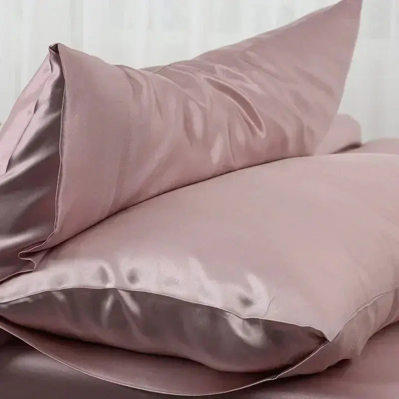 Blush pink satin silk pillow case with soft folds and side seam detail