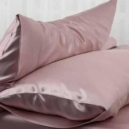 Blush pink satin silk pillow case with soft folds and side seam detail
