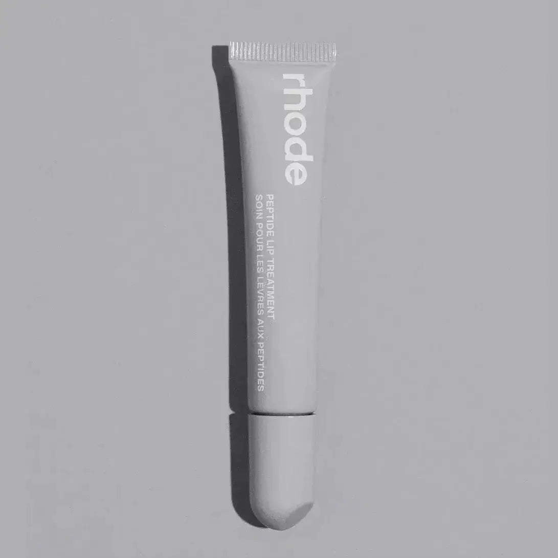 Silver Rhode lip balm tube with ribbed cap and squeeze tip