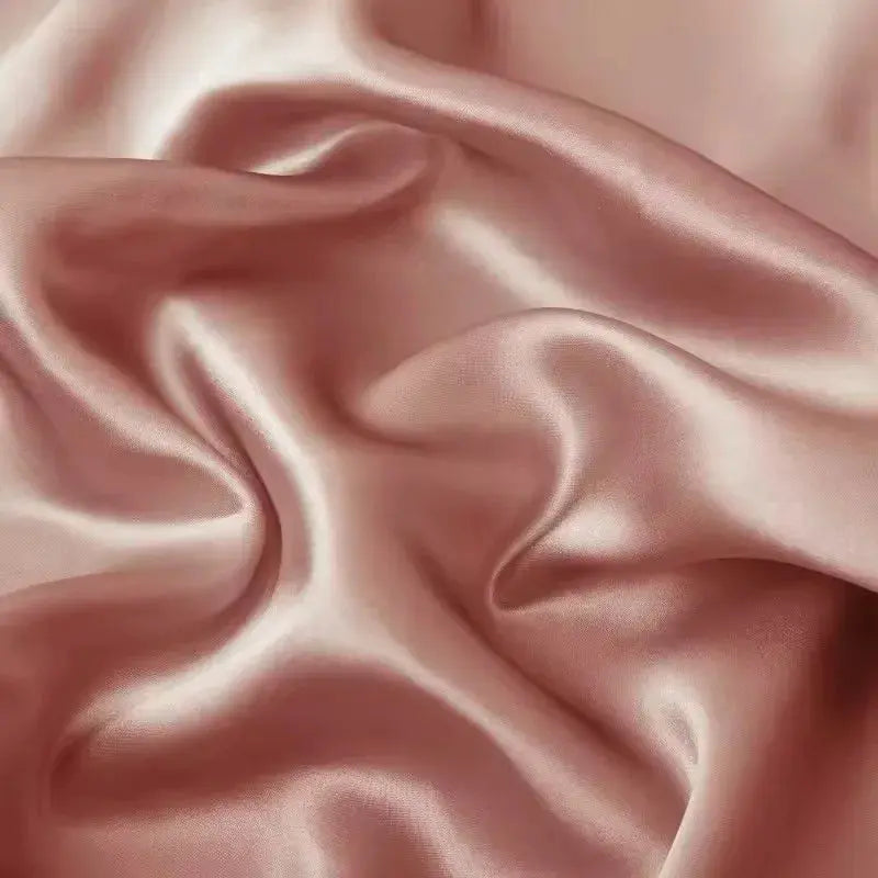 Pink silk pillowcase with smooth satin sheen and pleated accent flap