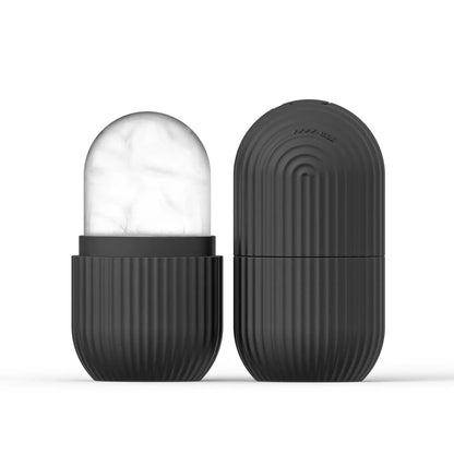 Dark gray silicone face ice cube mold with frosty ice top, closed