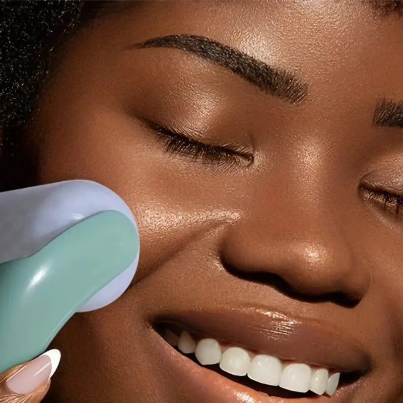 Light blue facial ice roller massager gliding along under-eye area for cooling