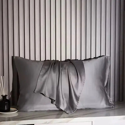 Grey silk pillowcase with smooth satin sheen and draped pleat flap