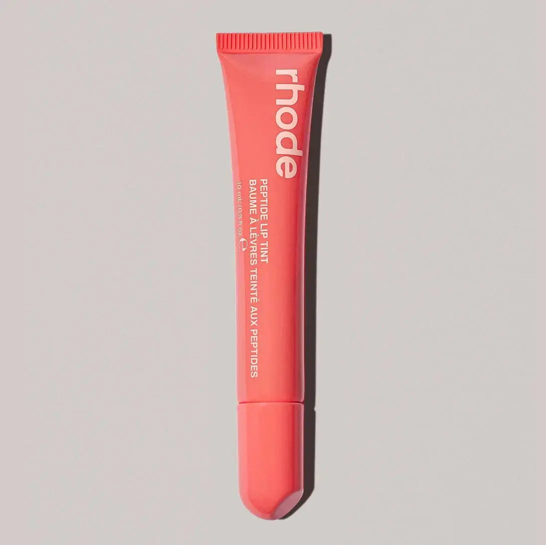 Rhode lip gloss tube in coral red pink with open applicator tip