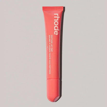Rhode lip gloss tube in coral red pink with open applicator tip