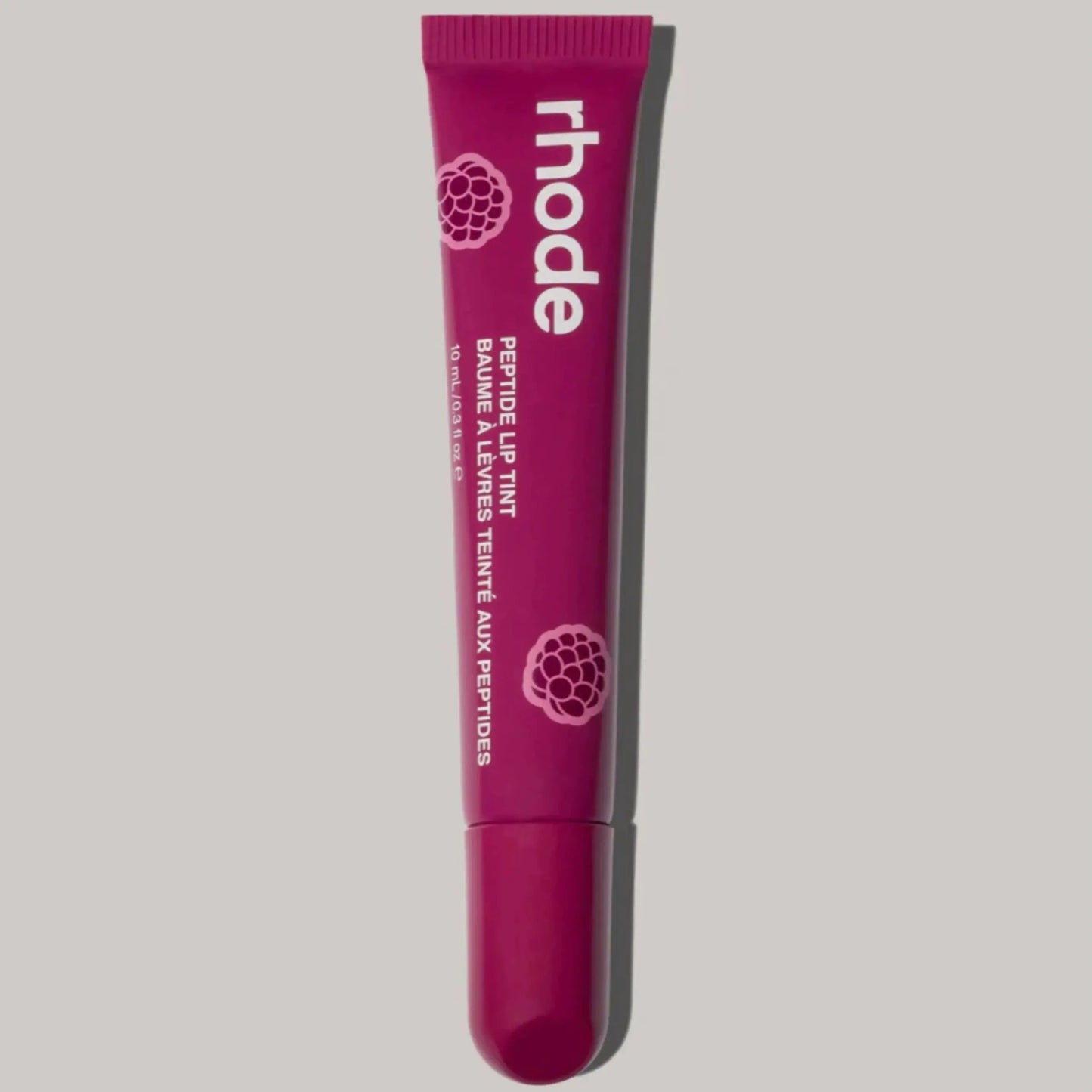 Purple lip glaze tube with applicator tip, branded “rhode” plump moisturizing lip gloss