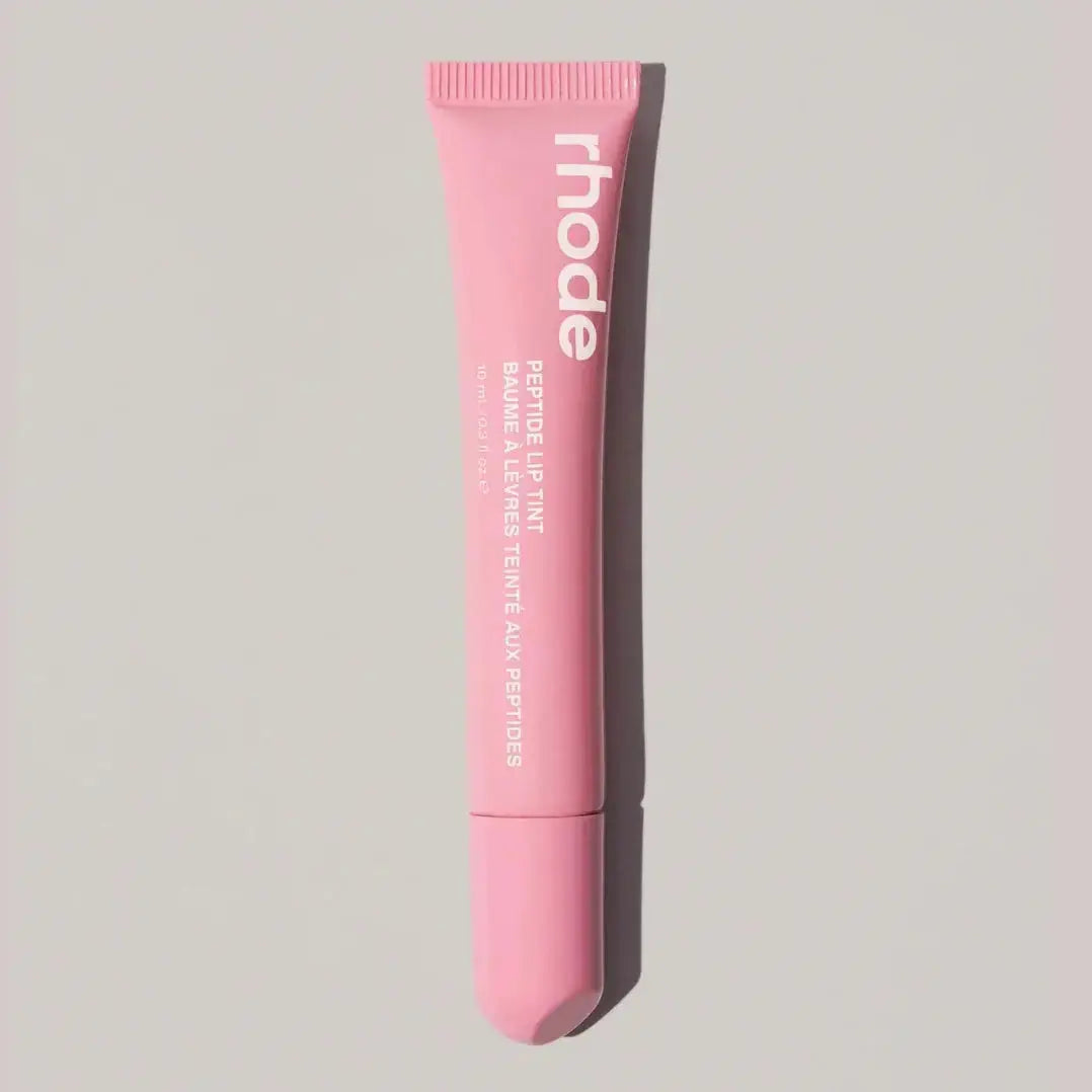 Lip gloss tube, pastel pink shade with ribbed cap and transparent tube tip