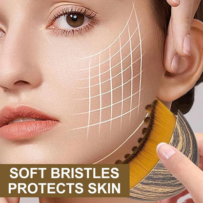 Lymphatic sculpting face brush held near cheek with soft golden bristle head