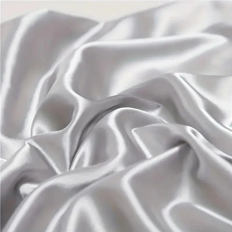 White silk pillowcase fabric close-up with glossy folds