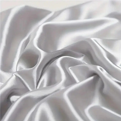 White silk pillowcase fabric close-up with glossy folds