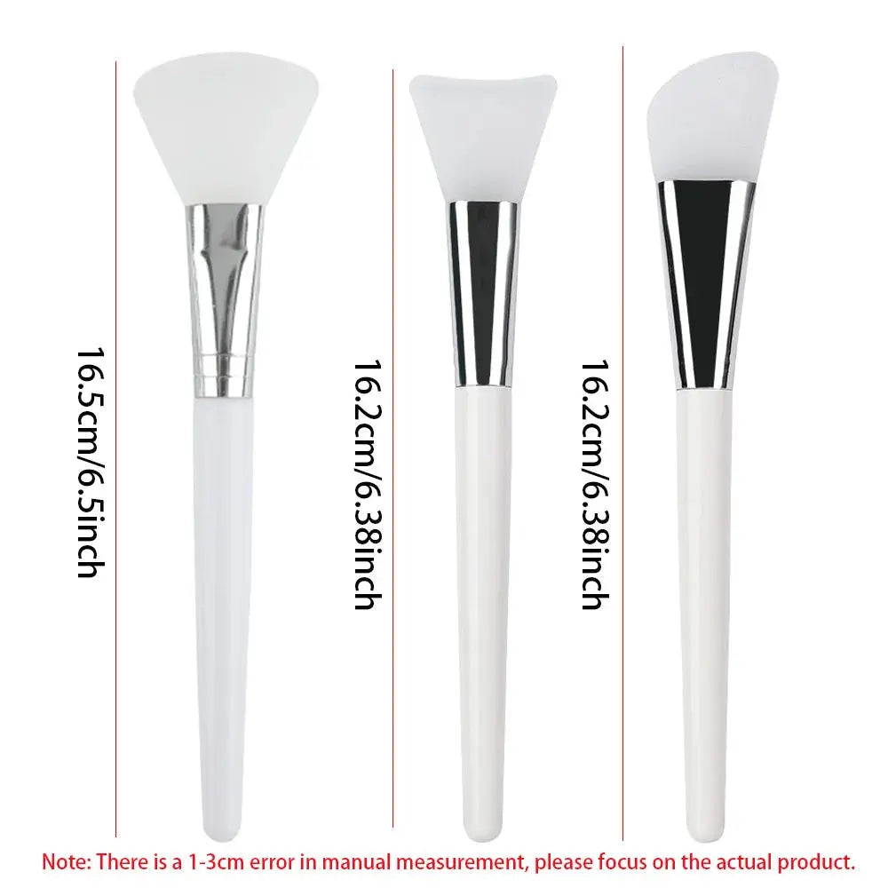 Three silicone face mask applicator brushes showing different heights, white handles and silver ferrules