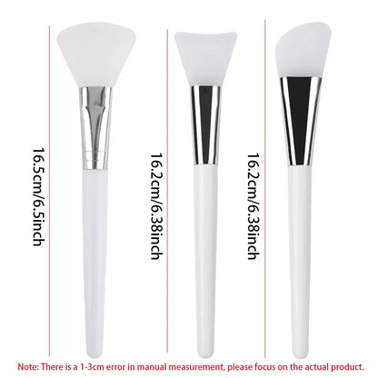 Three silicone face mask applicator brushes showing different heights, white handles and silver ferrules