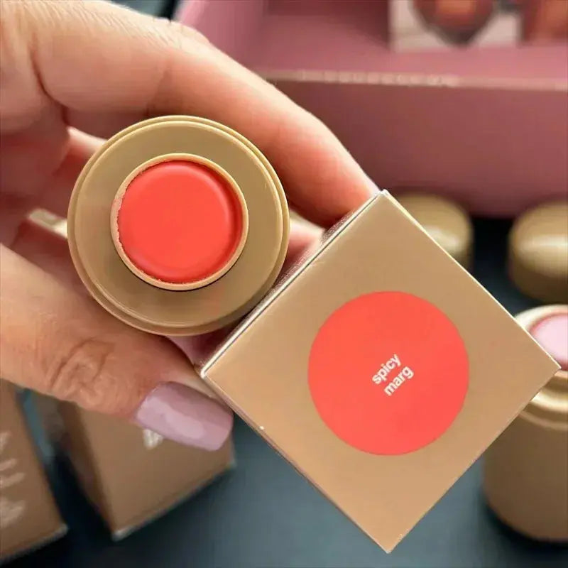 Rhode lip glaze lip gloss in coral-red circular cap labeled “spicy marg”