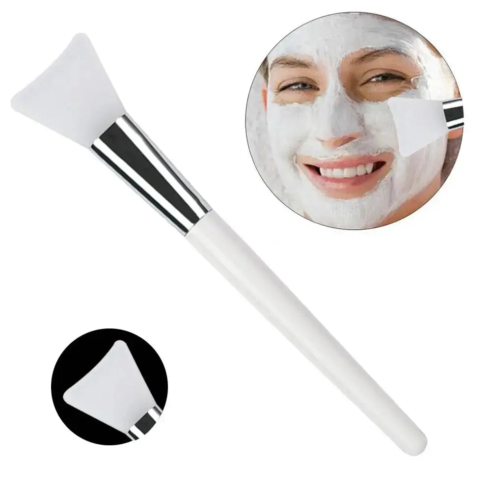 Silicone face mask applicator brush with white handle and soft triangular silicone head