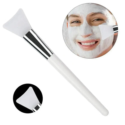 Silicone face mask applicator brush with white handle and soft triangular silicone head