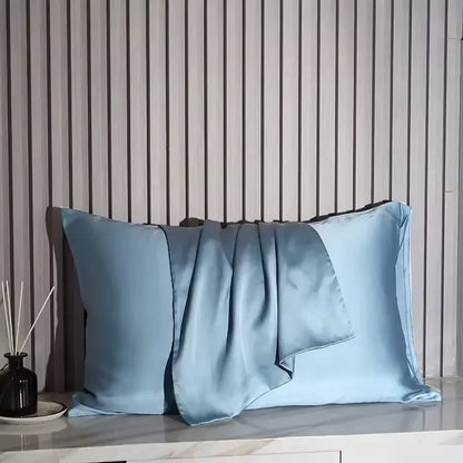 Light blue silk pillowcase with glossy satin finish and folded accent flap