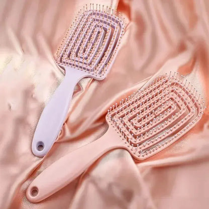 Pink anti-static massage hair brush comb with vented bristle pad and oval handle grip