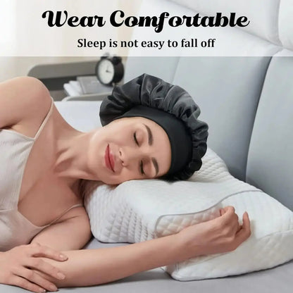 Satin sleep bonnet on woman lying in bed, wide brim and elastic band visible.