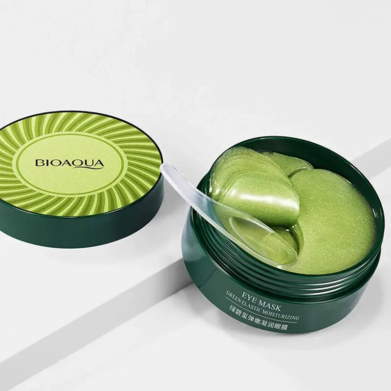 Green eye mask gel jar with open lid and white scoop