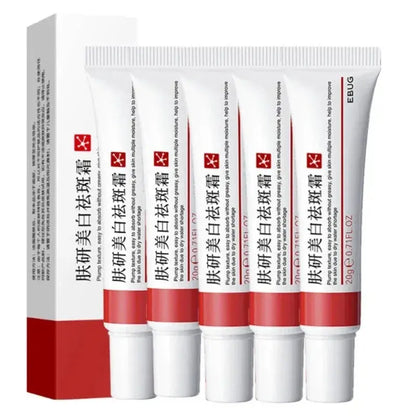 Multiple freckle whitening cream tubes lined up with cartons, white and red