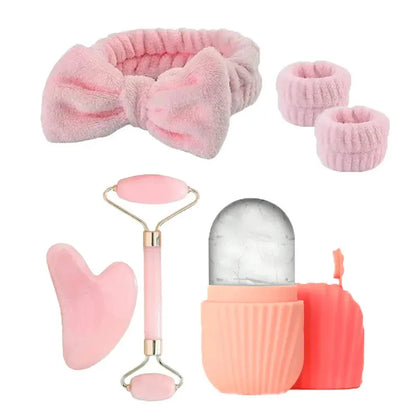Pink facial roller set with rose-gold frame, gua sha scraper and ice roller cup