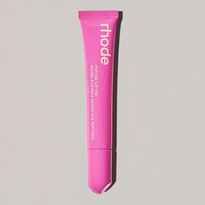 Rhode lip gloss tube in light pink with open applicator tip
