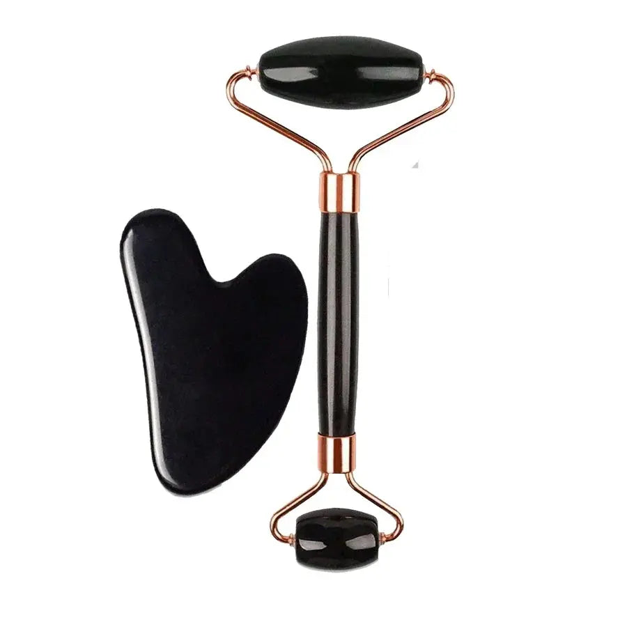 Black silicone face roller with copper-toned metal handle and two gua-sha heads