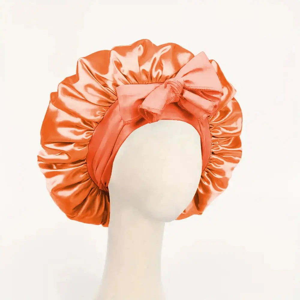 Orange satin silk sleep bonnet with ruched ruffle edge and adjustable tie band