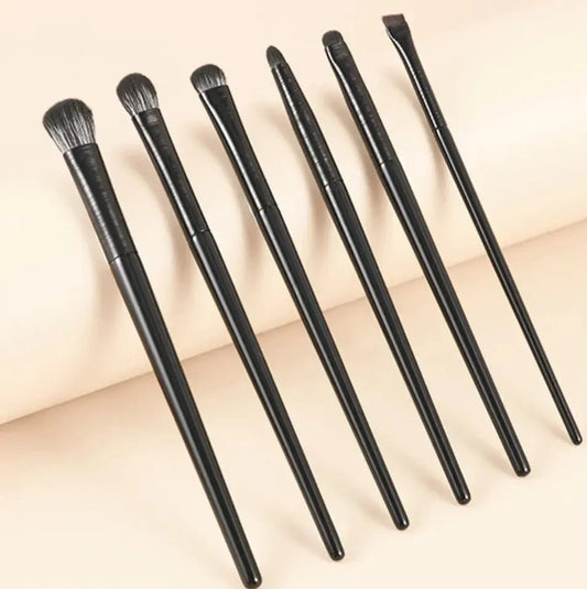 Set of 6 eye makeup brushes with dark handles and soft bristles, angled view