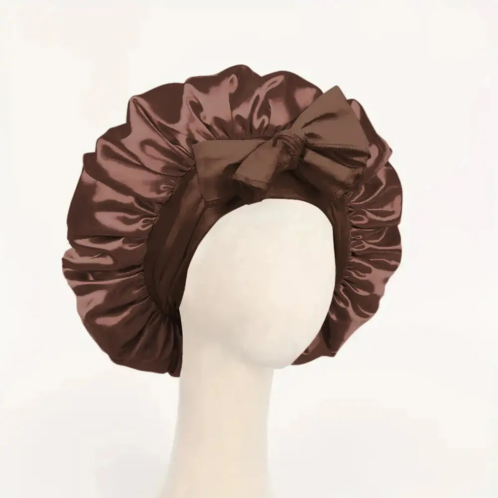 Dark brown satin bonnet with gathered ruffles and front bow tie, adjustable band