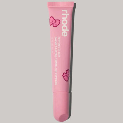 Pink Rhode lip balm tube with bow graphics and squeeze tip