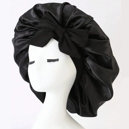 Black satin hair bonnet with gathered crown and front tie bow for sleep
