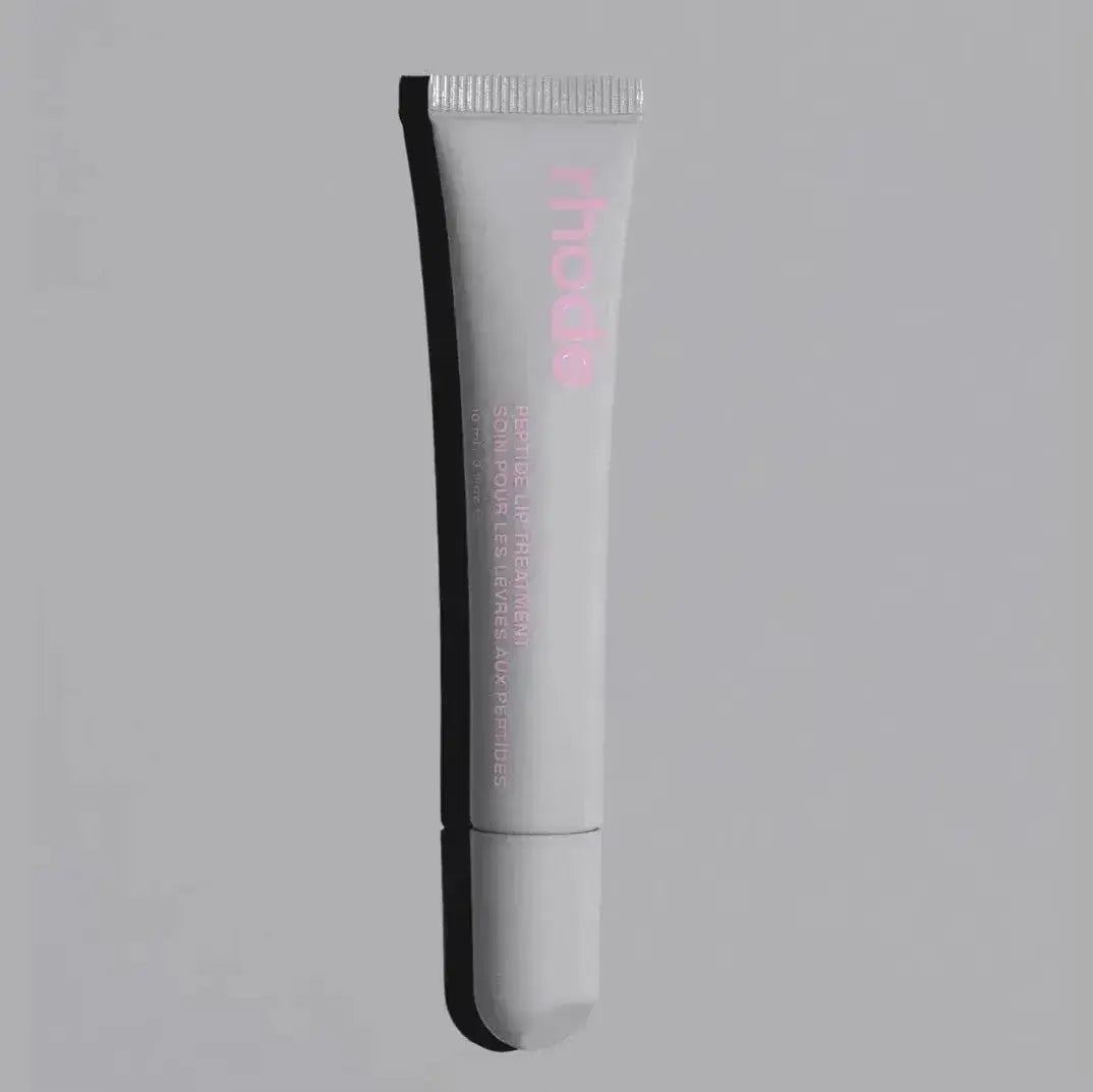White lip glaze tube with “rhode” logo and applicator tip