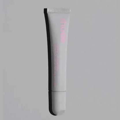 White lip glaze tube with “rhode” logo and applicator tip