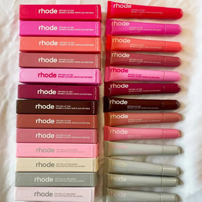 Assorted Rhode lip balm tubes in various colors, stacked on display