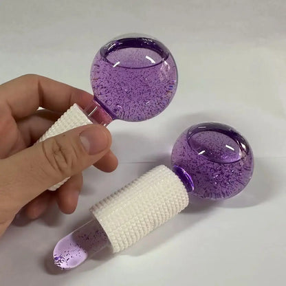 Hand holding purple glitter ice crystal ball facial roller with white textured handle, 1 tool