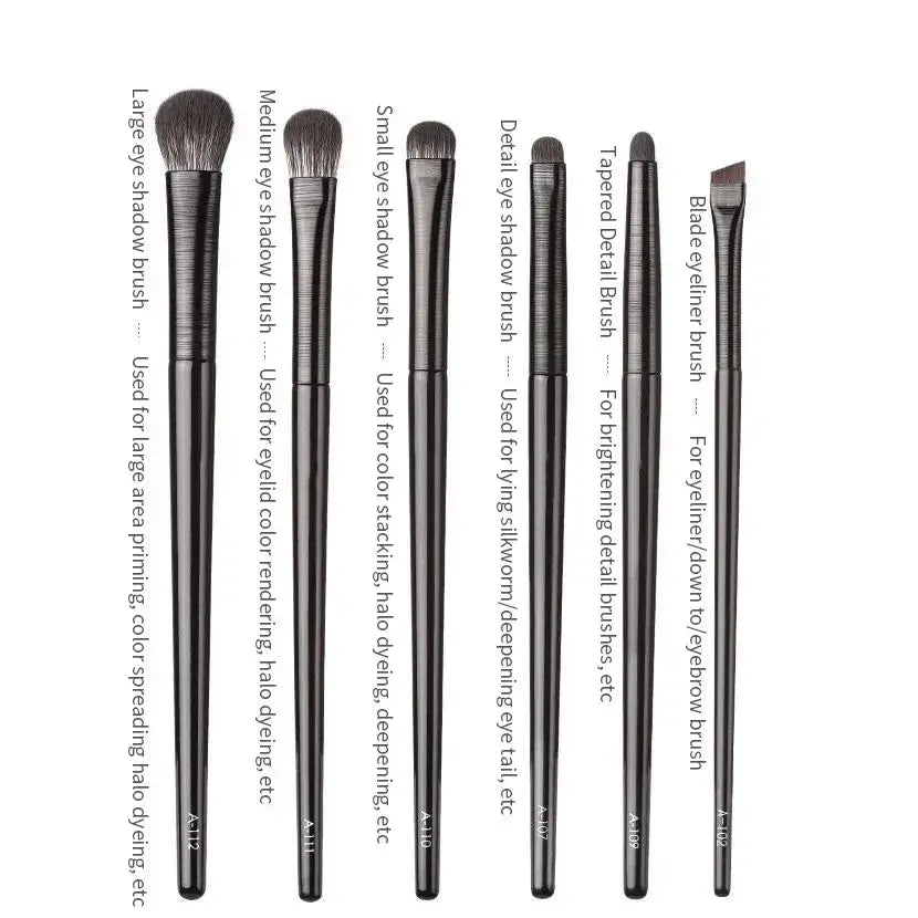 Six eye makeup brushes with dark handles, varied tips for eyeshadow, eyeliner, brows