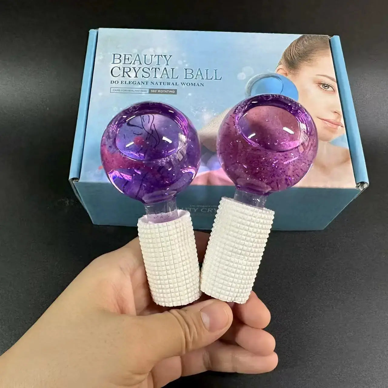 Boxed beauty crystal ball ice rollers showing purple glitter pair with white textured handles