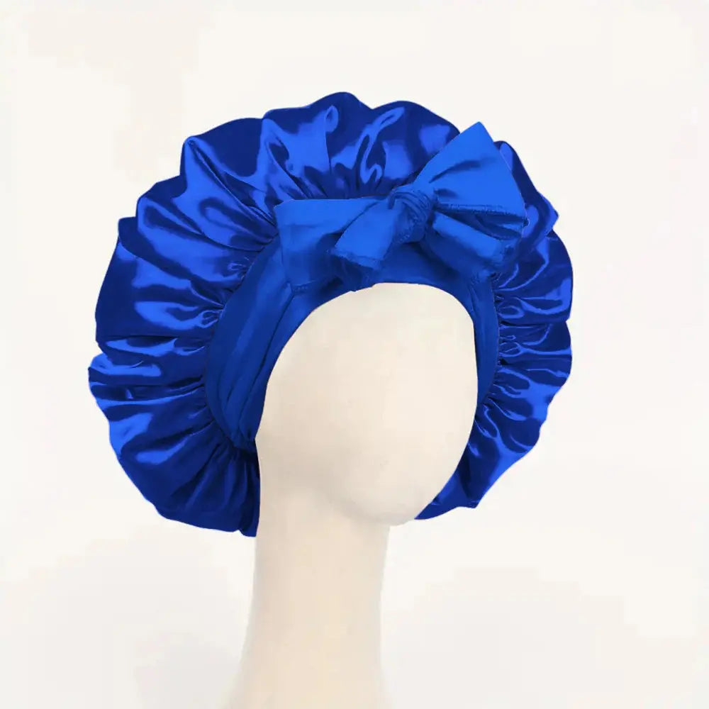 Royal blue satin hair bonnet with gathered crown and front tie bow for sleep
