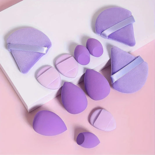 Purple egg-shaped makeup sponges with flat edges, assorted sizes.