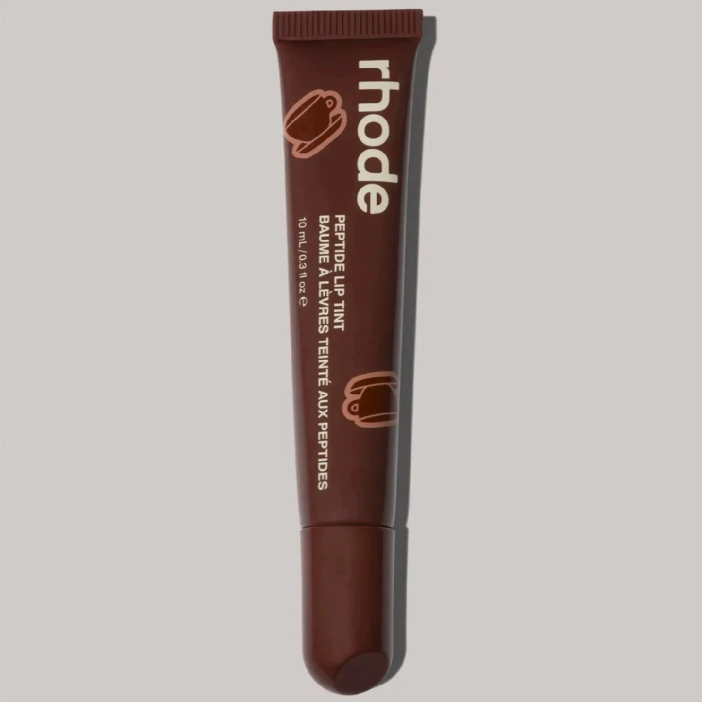 Brown Rhode lip balm tube with ribbed cap and squeeze tip