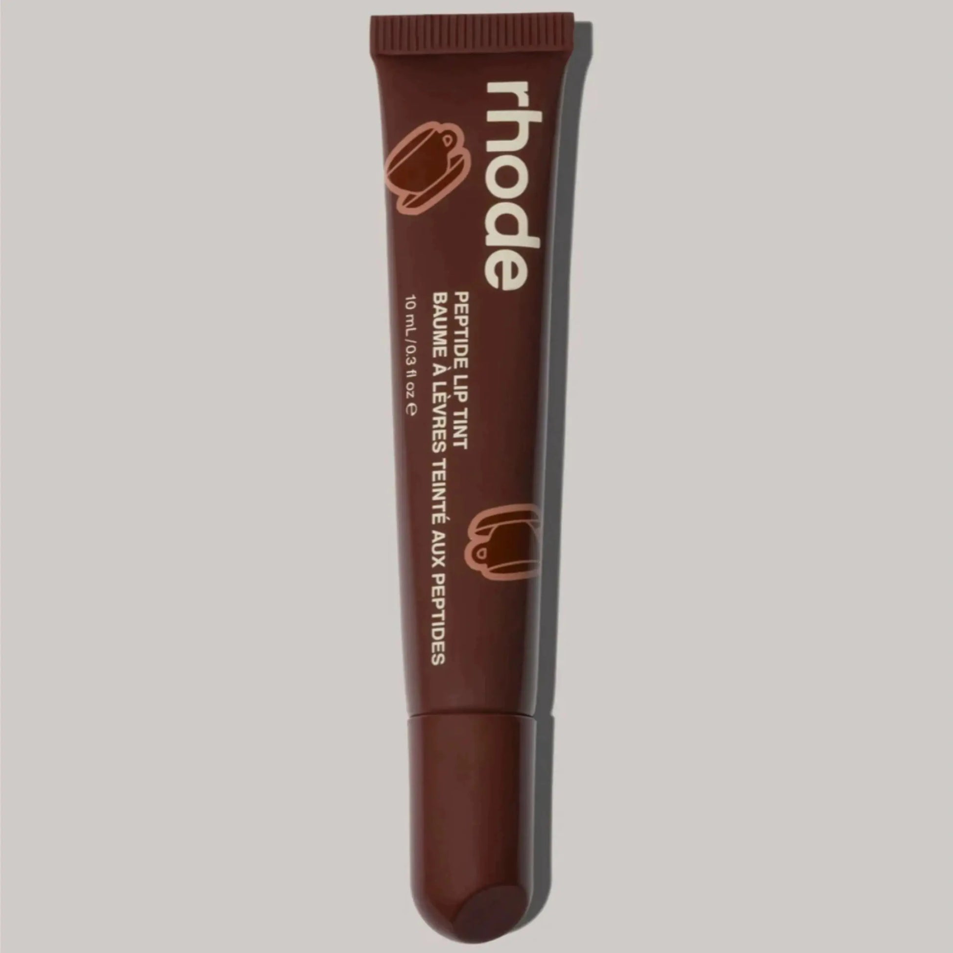 Brown Rhode lip balm tube with ribbed cap and squeeze tip