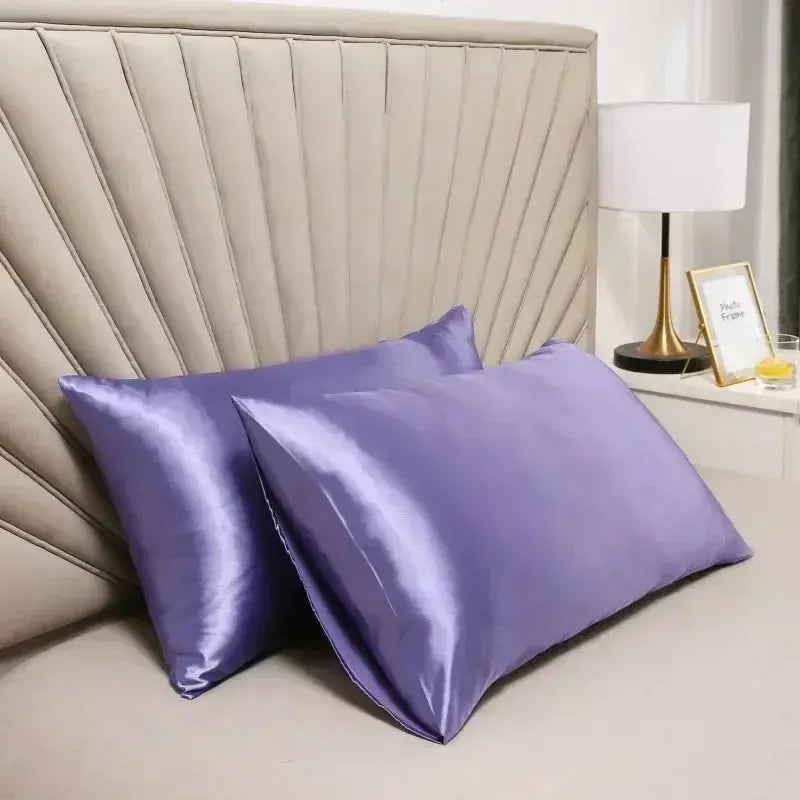 Lavender satin silk pillow case pair on a bed with smooth fold texture