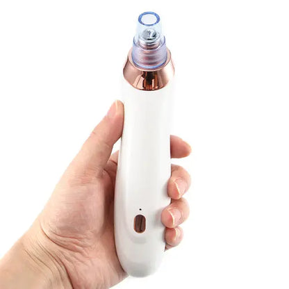 Clarity blackhead extractor in hand, white body with rose-gold cap and oval opening