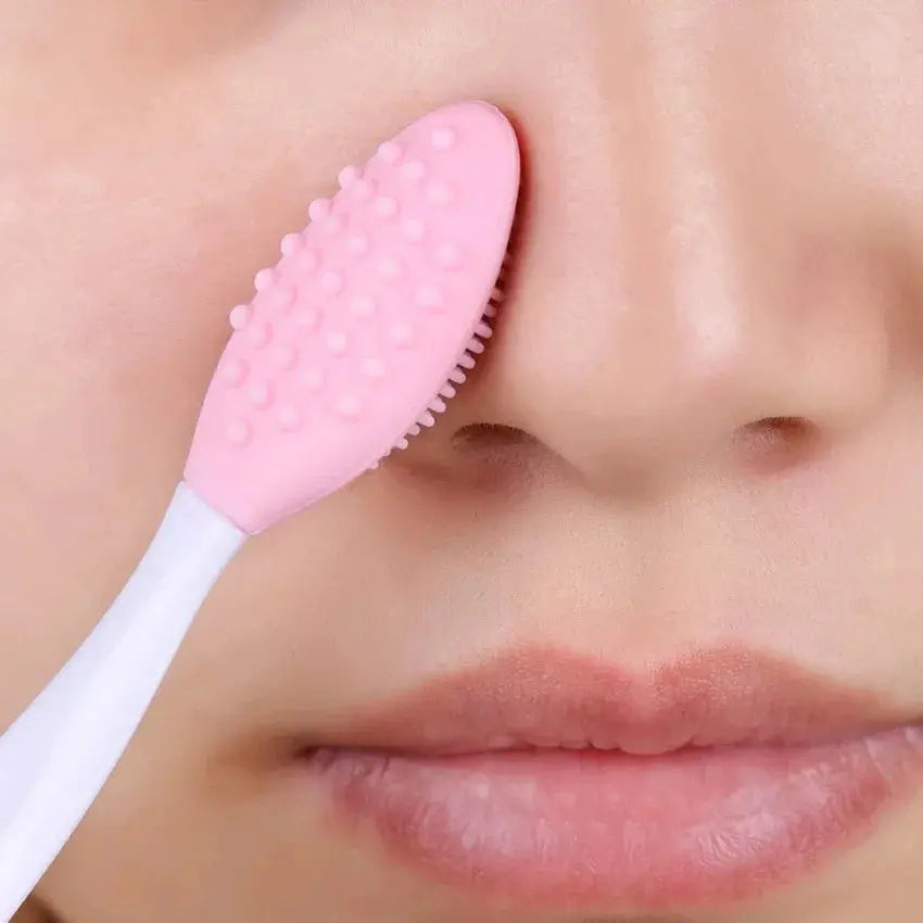 Pink silicone nose cleaning brush on face near nostril