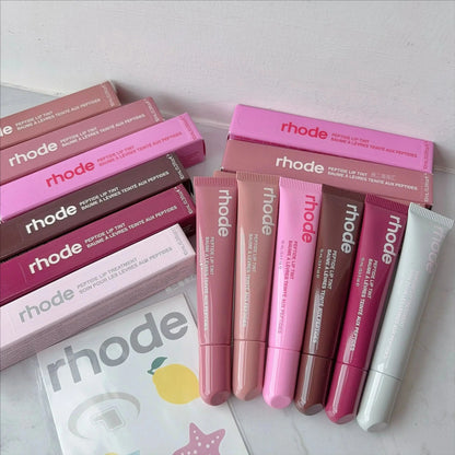 Rhode lip glaze lip glosses with labeled tubes and pink-toned boxes